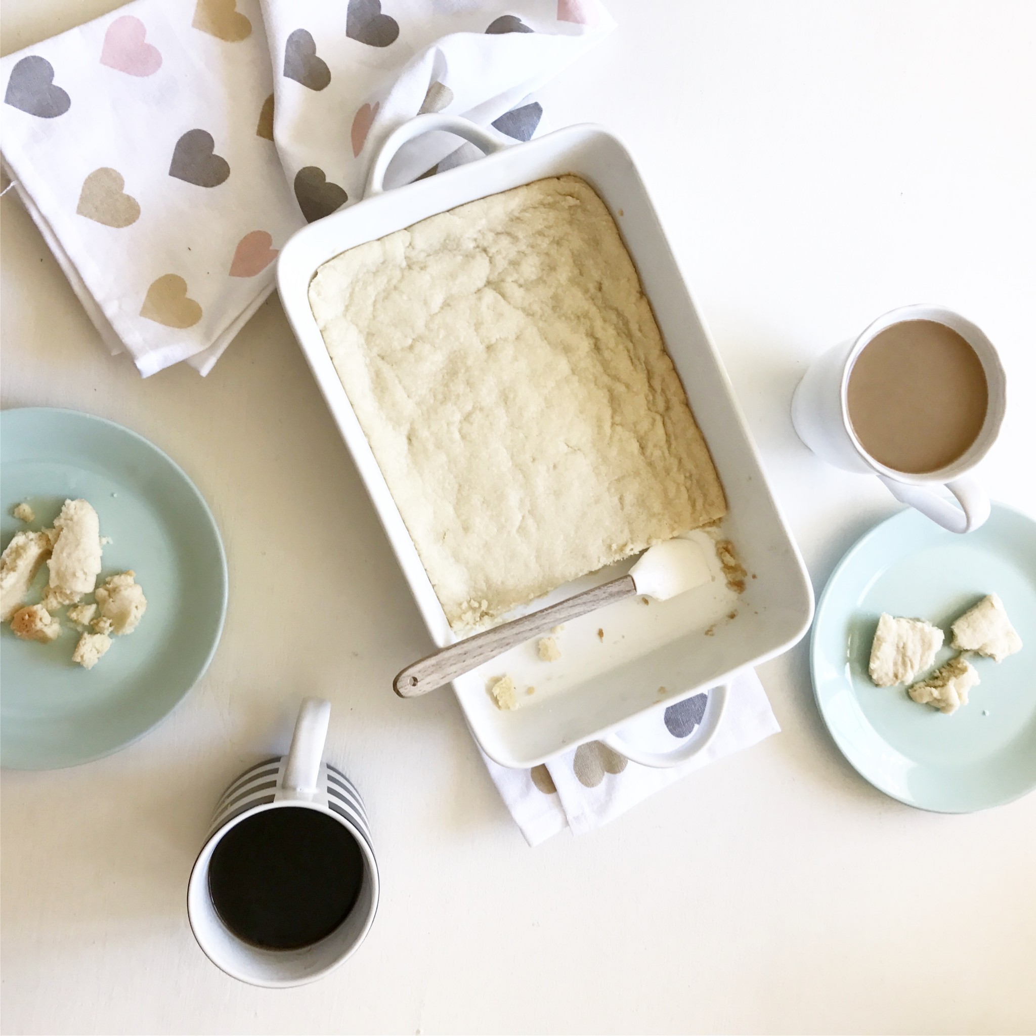 Homemade shortbread recipe in a white dish with coffee