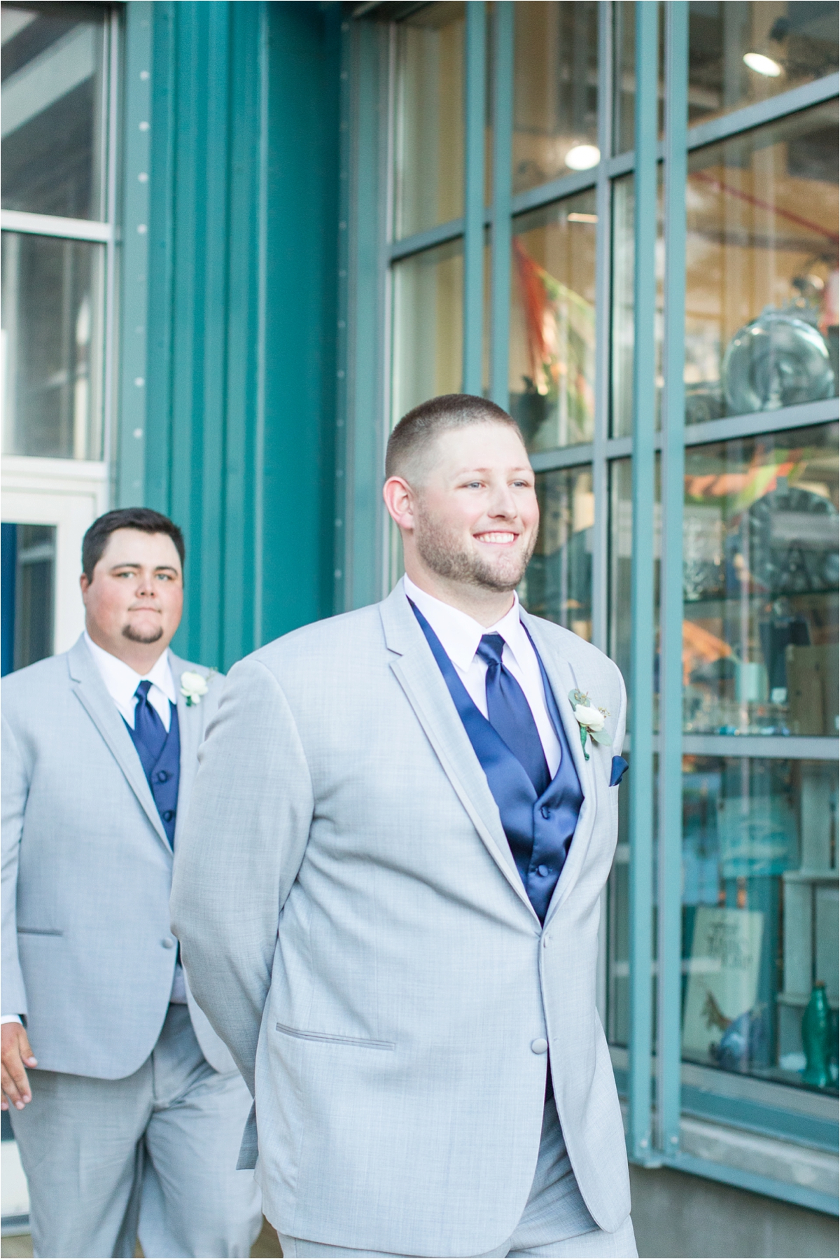 groom-first-look-at the end of the aisle-navy-blue-wedding-vest-tie