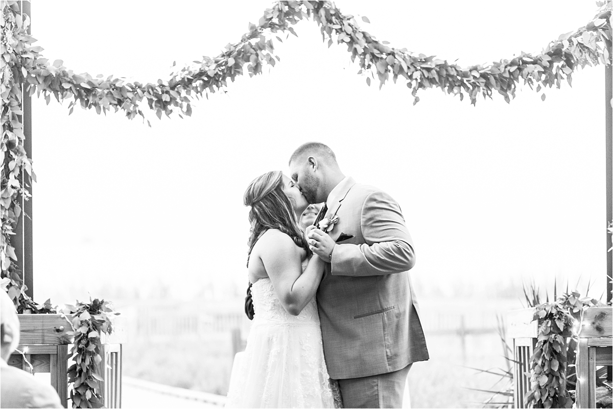 wedding-ceremony-first-kiss-bride-groom-dauphin island-beach-alabama-photographer