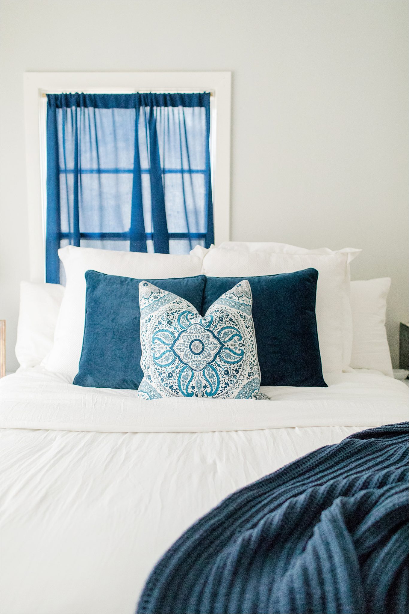 navy blue-accent-color-house to home-on a budget-white-airy-comforter-pillow-design