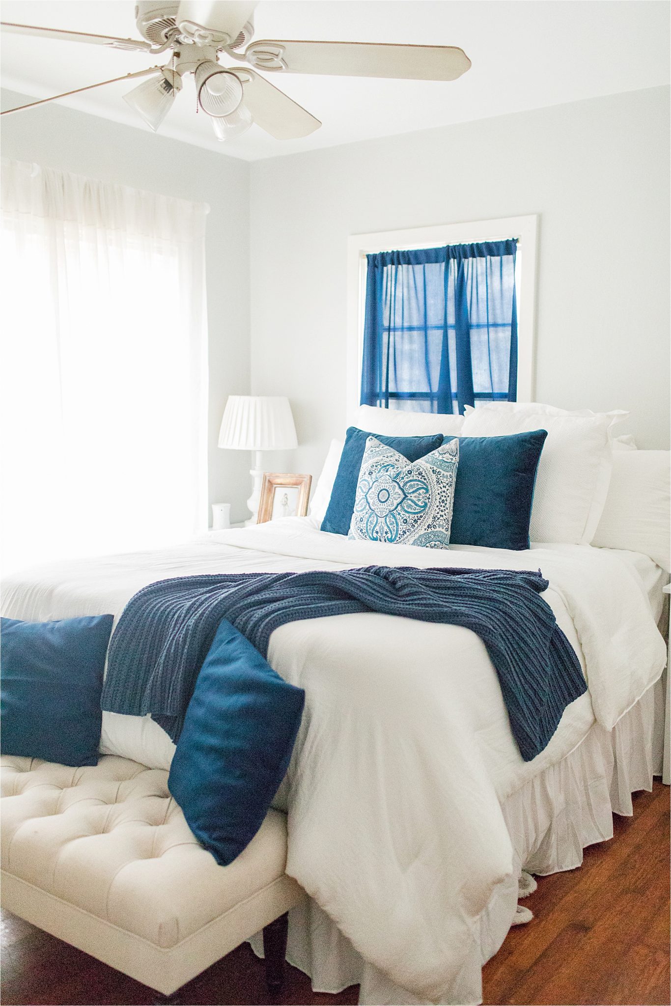 navy blue-accent-color-house to home-on a budget-white-airy-comforter-pillow-design