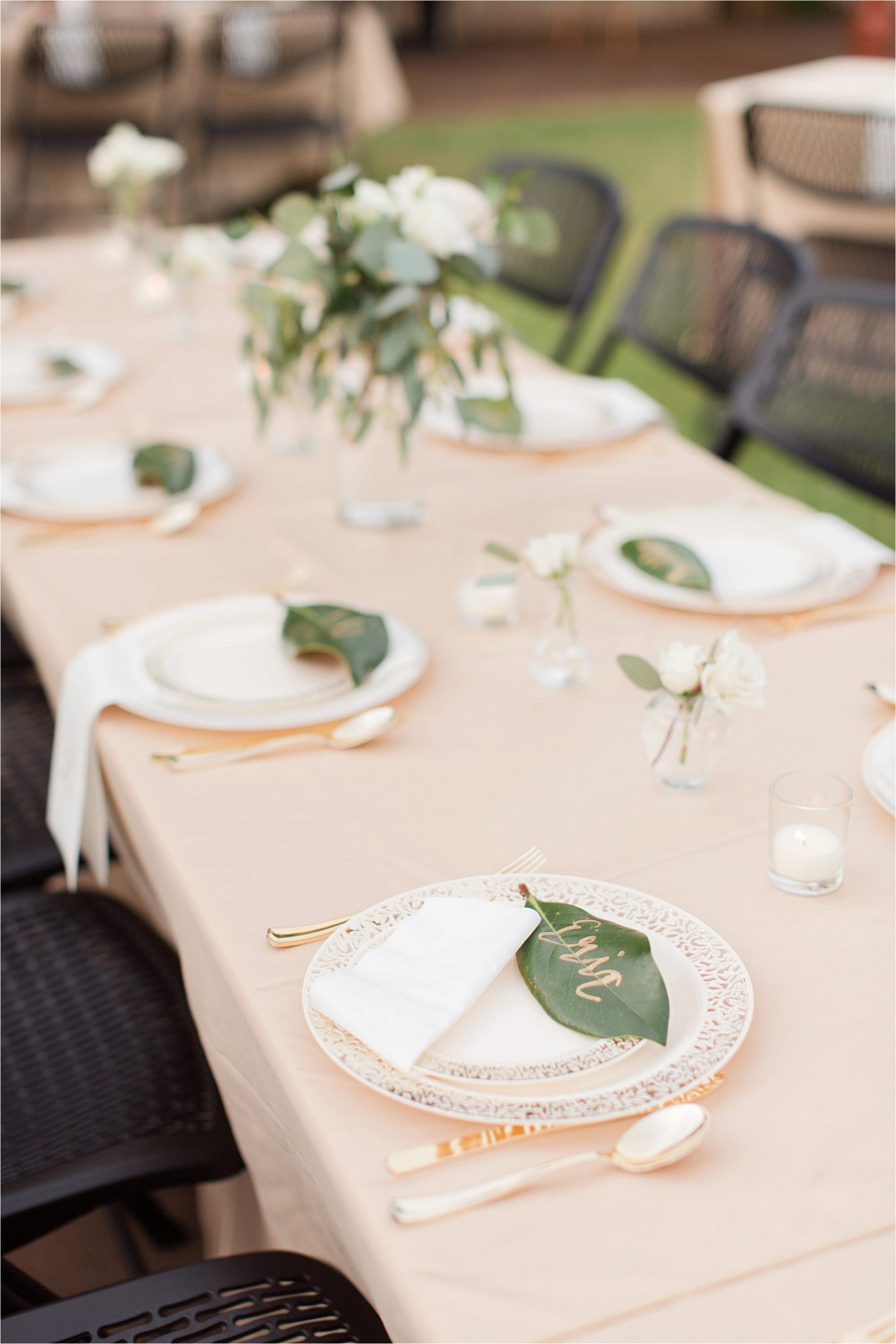 wedding-reception-place-setting-groom-champagne-blushes-nuetrals-white-roses-magnolia-leaves-gold-writing