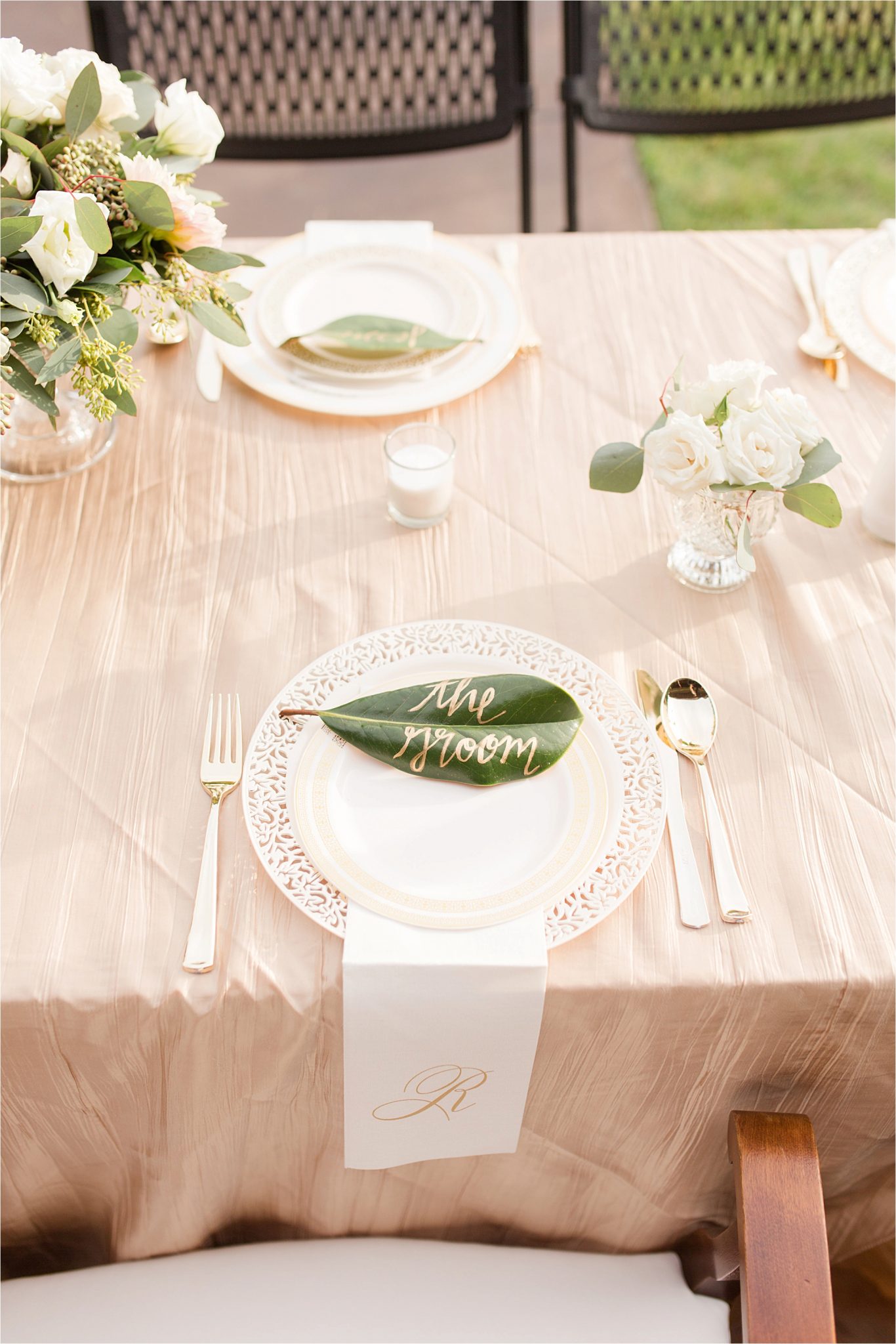 wedding-reception-magnolia-leaves-place-setting-groom-champagne-blushes-nuetrals-white-roses