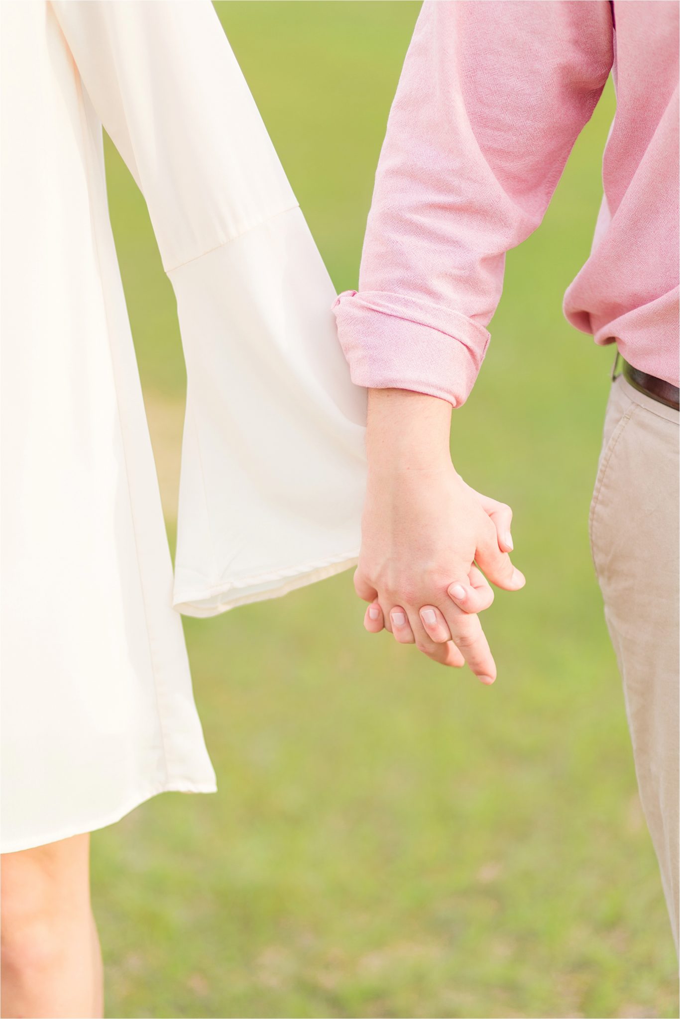 Engagement photos-bride and groom-holding hands-pastels and ivory-Alabama wedding photographer