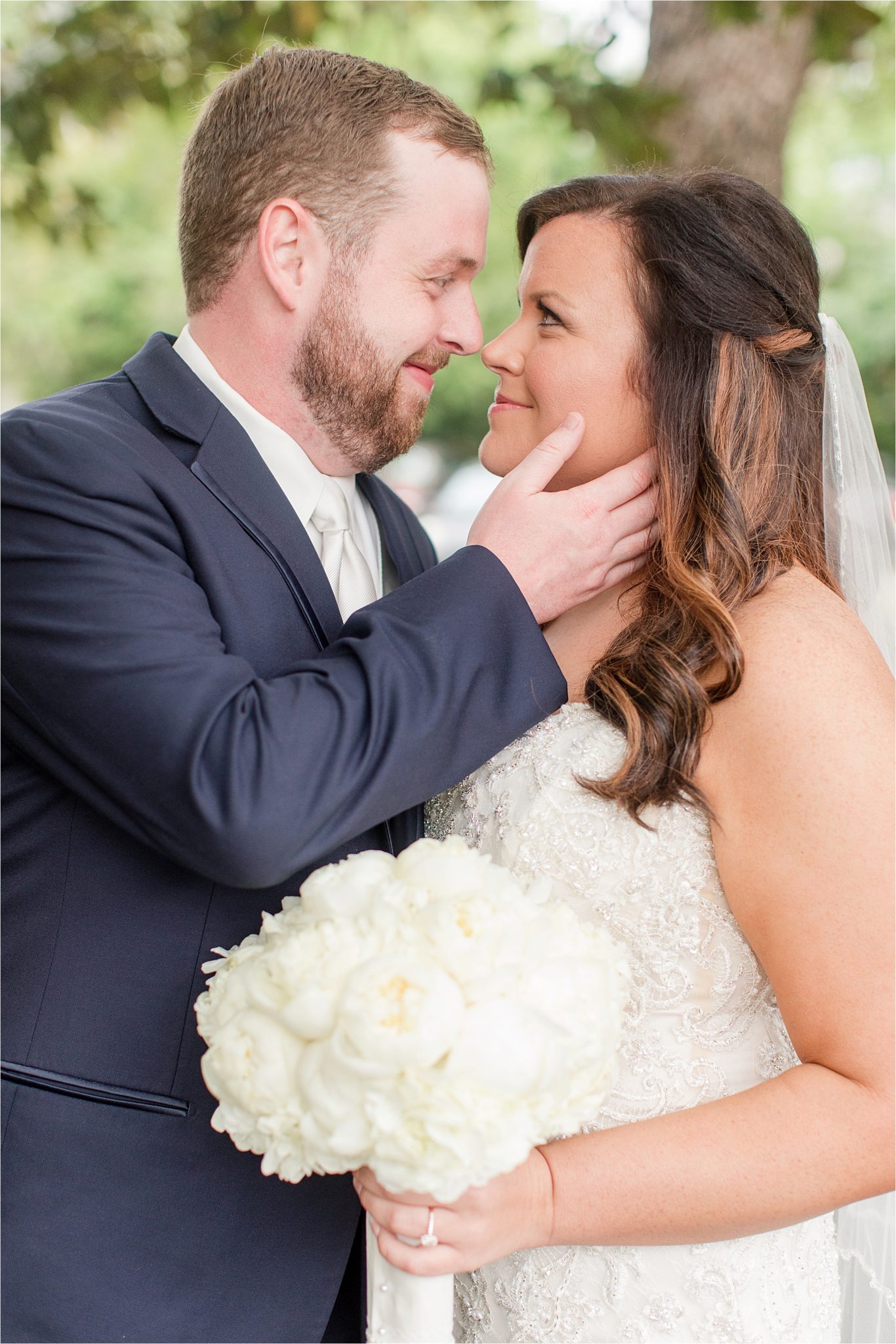 bride and groom photos-navy suit-white roses-wedding day photos-white tie-husband and wife photos