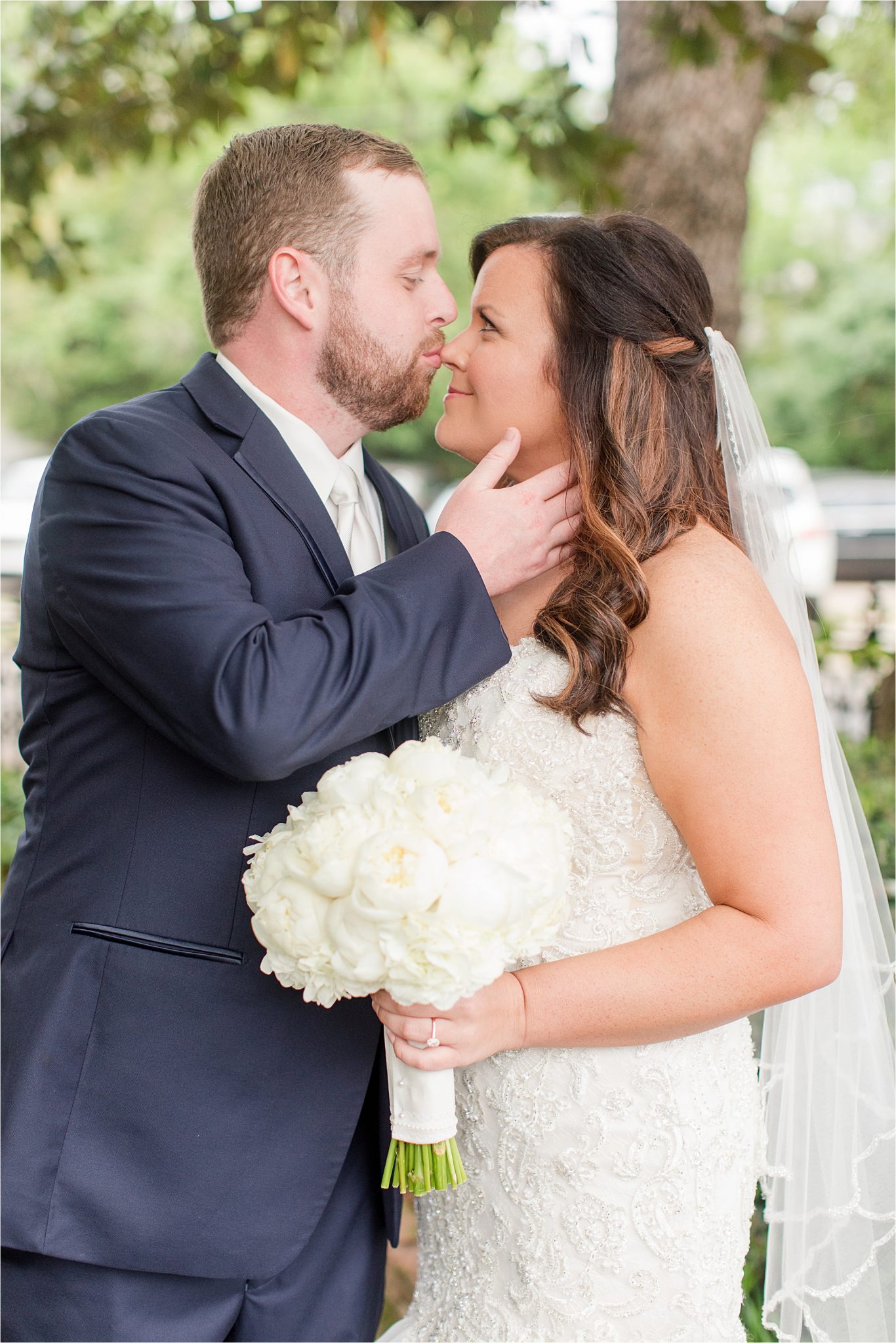 bride and groom photos-navy suit-white roses-wedding day photos-white tie-husband and wife photos-precious bride and groom photos-nose kisses