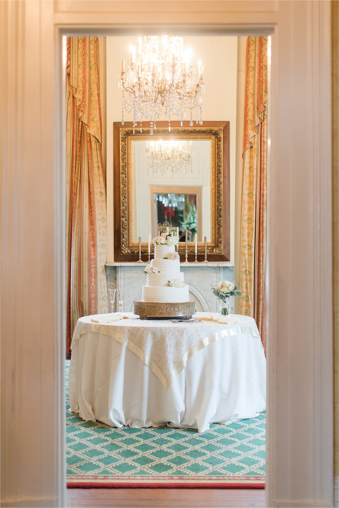 ezell house wedding reception-wedding cake- three tier-rustic cake stand-under of flowers-historic downtown mobile-alabama