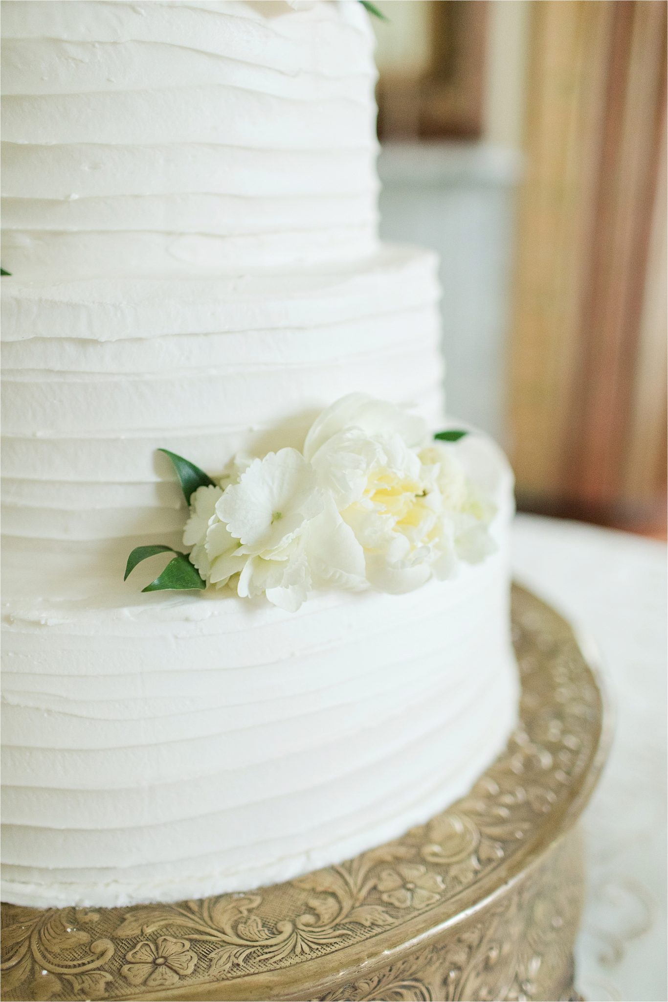 wedding cake-buttercream frosting-real flowers-ornate cake stand-rustic