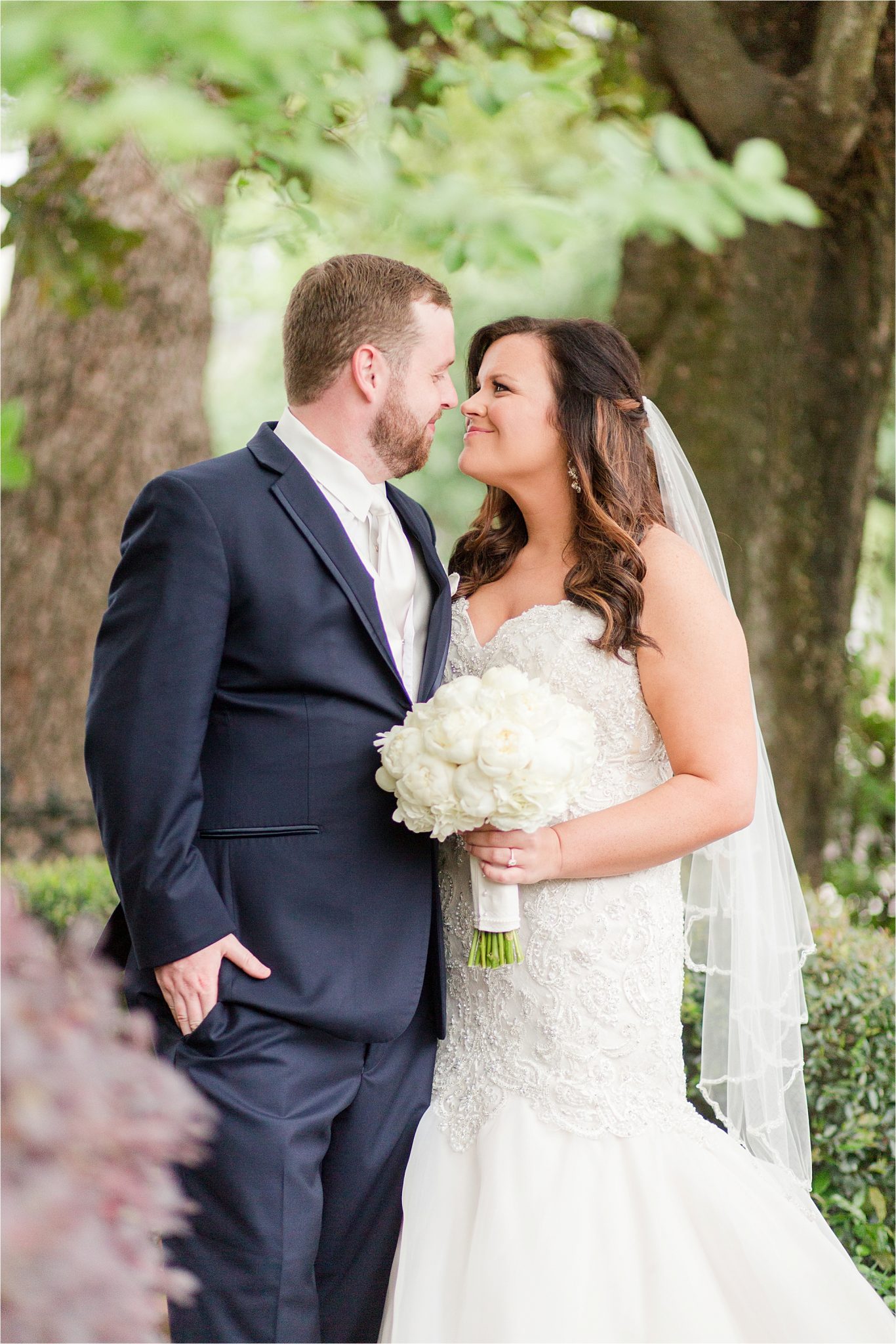 bride and groom photos-navy suit-white roses-wedding day photos-white tie-husband and wife photos