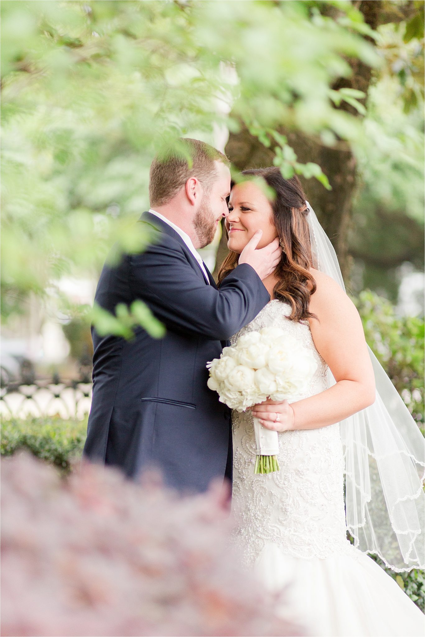 bride and groom photos-navy suit-white roses-wedding day photos-white tie-husband and wife photos