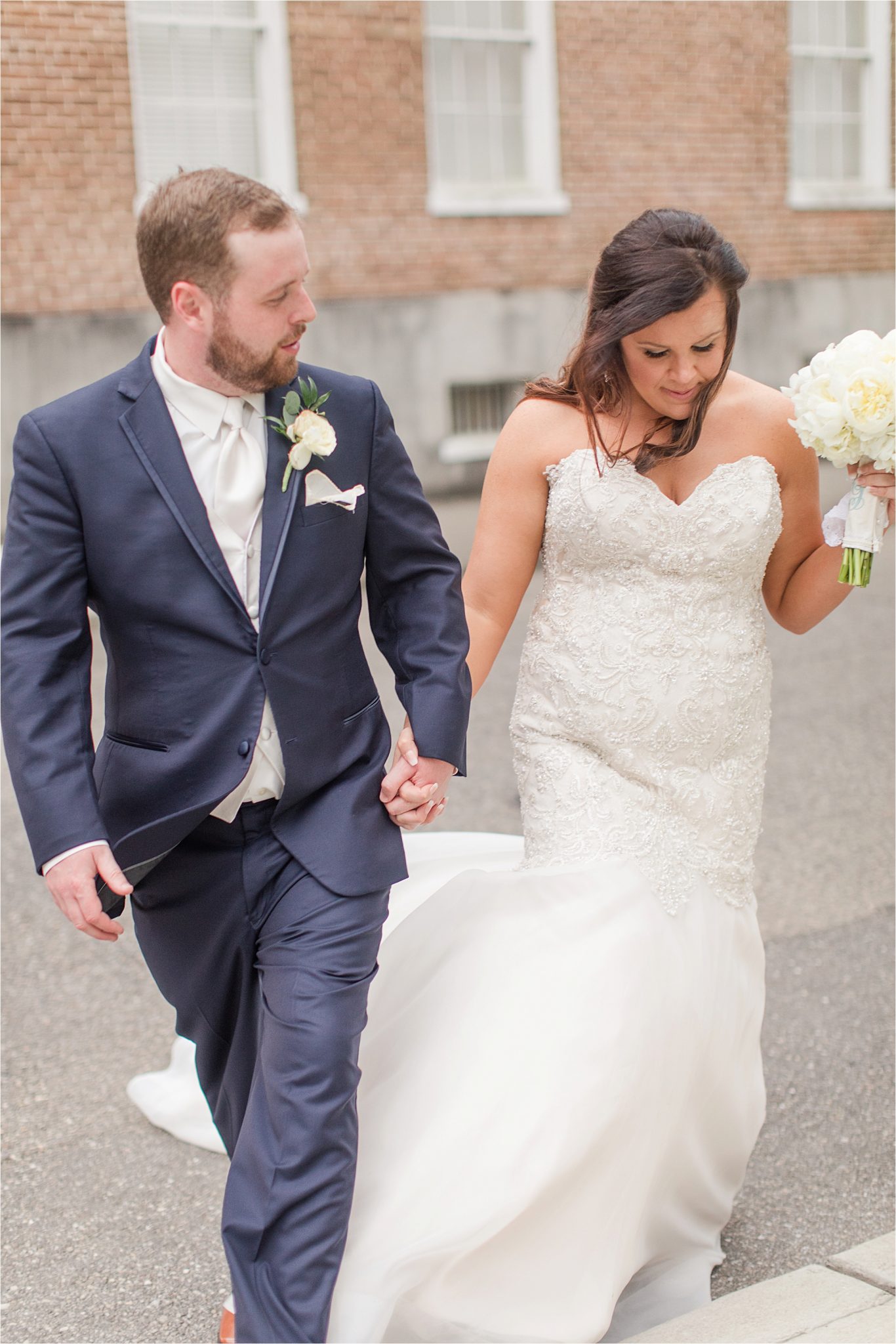 bride and groom photos-navy suit-white roses-wedding day photos-white tie-husband and wife photos-holding hands-navy suit-white tie