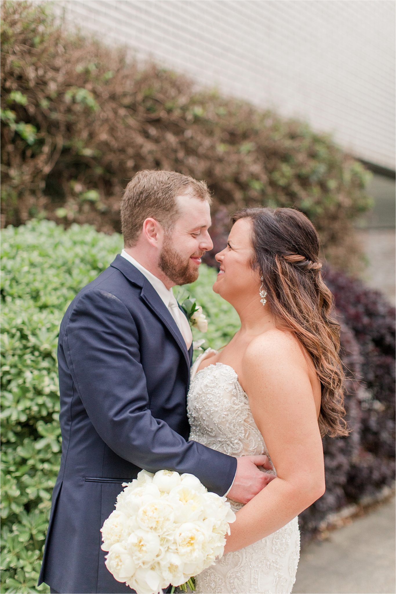 bride and groom photos-navy suit-white roses-wedding day photos-white tie-husband and wife photos