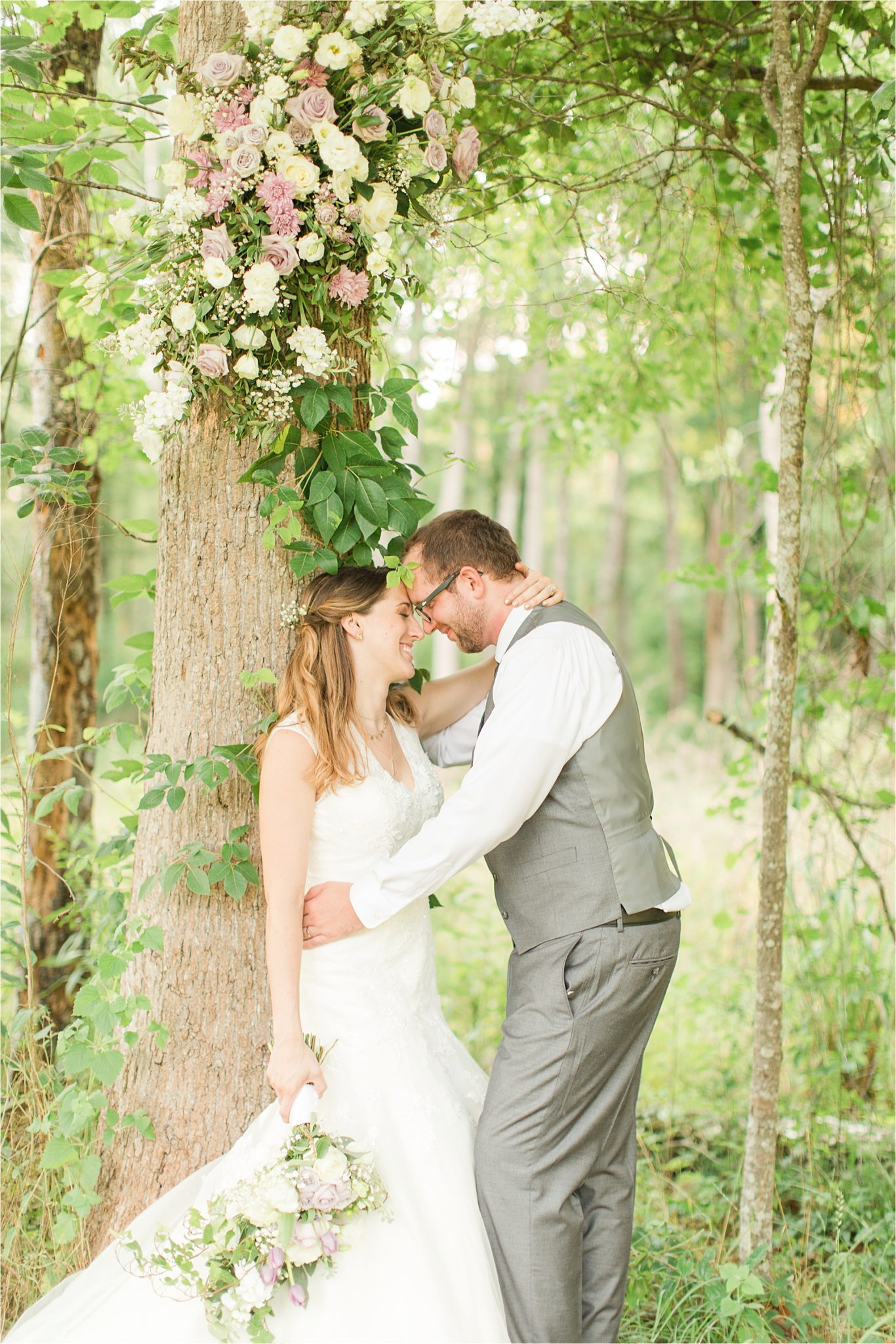 decorate trees with wedding flowers-bride and groom portraits-wedding day-grey grooms suit-vest-lavender flowers