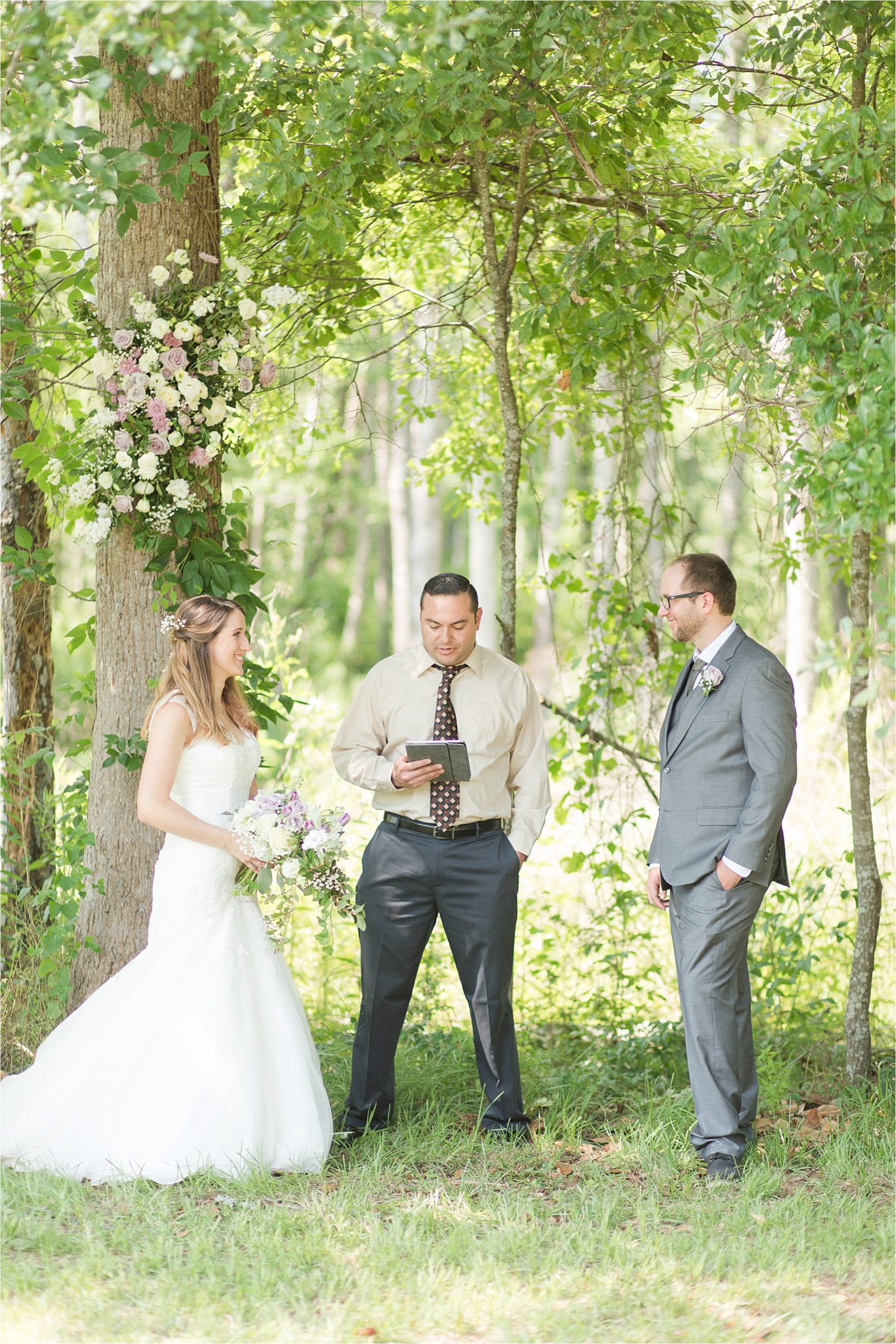 Backyard Wedding in the Country-decorate trees with flowers-woods as wedding backdrop-ceremony in front of forest-woods frame bride and groom ceremony