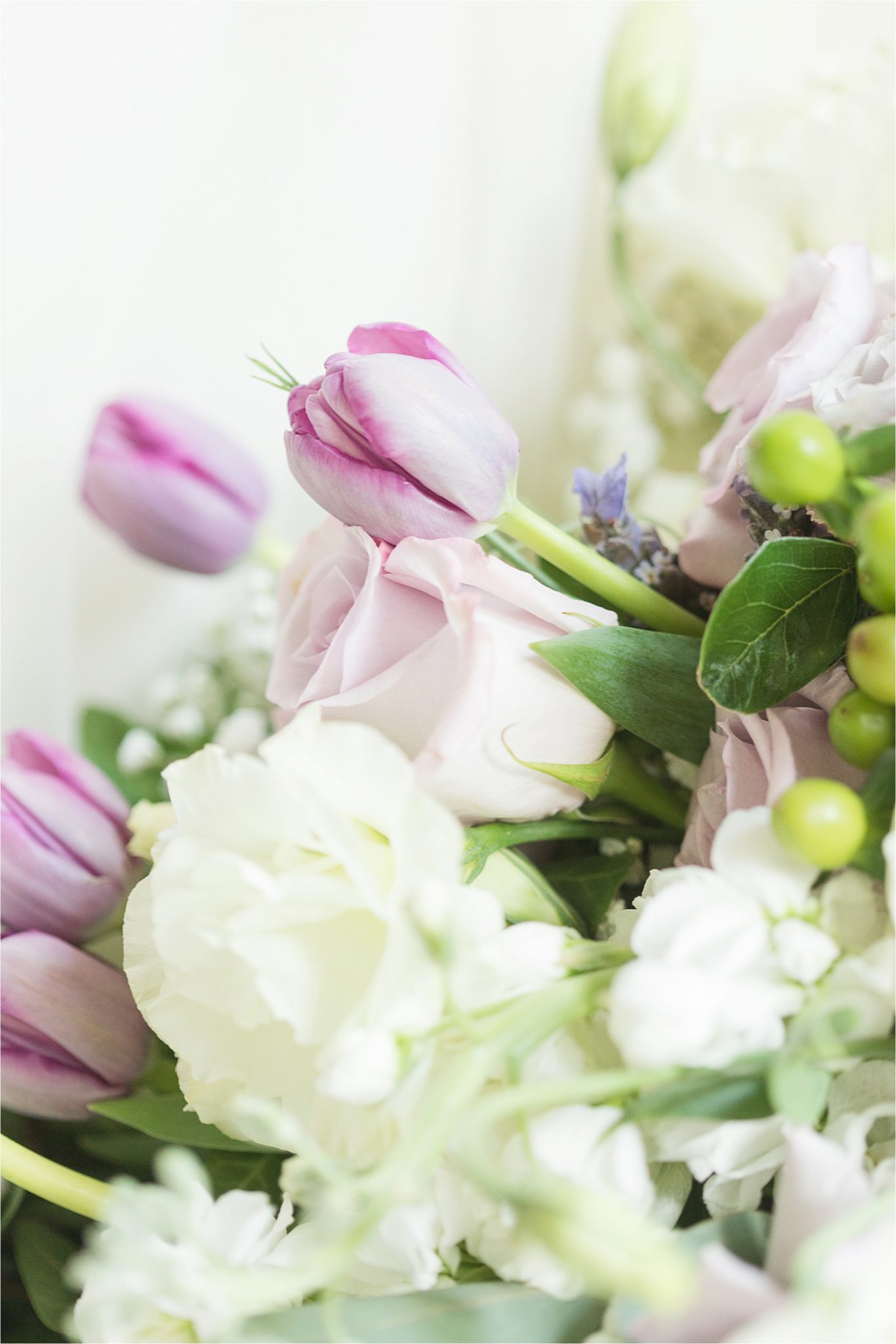 purple and pink-tulips-wedding bouquet-white flowers-roses-greenery-hypericum berries