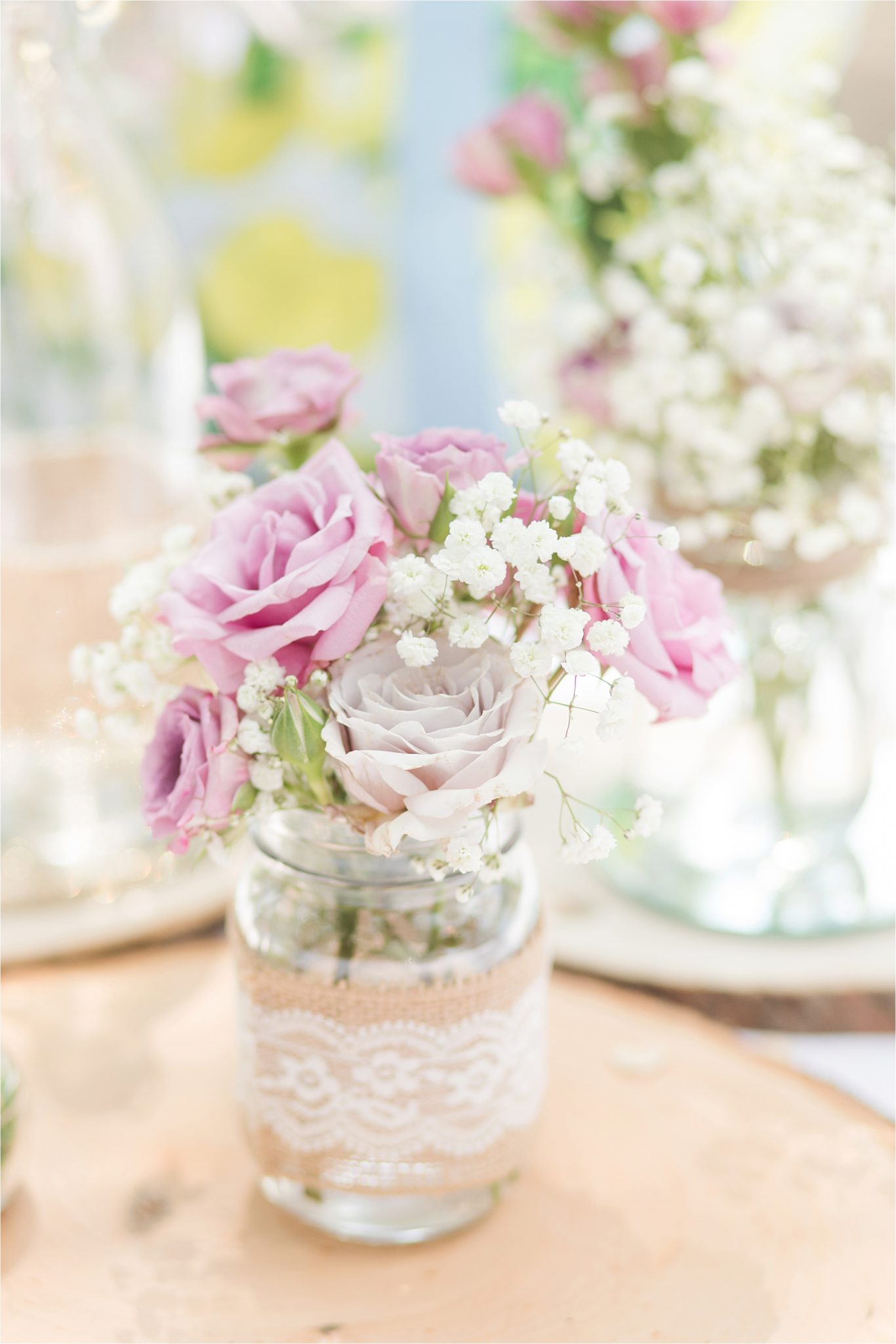 pink and purple rose center pieces-mason jars-lace-babies breath