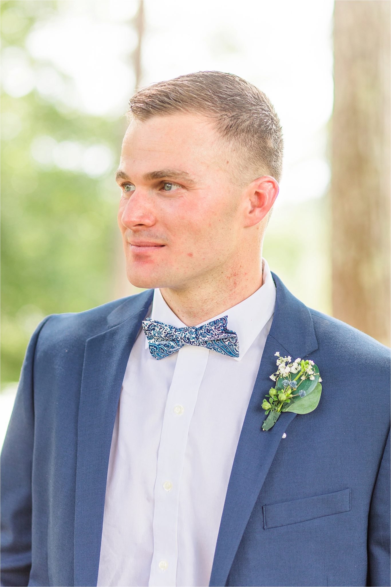 blue-grooms-suit-patterned-bow-tie-clean-cut-fitted-white-dress-shirt-portrait