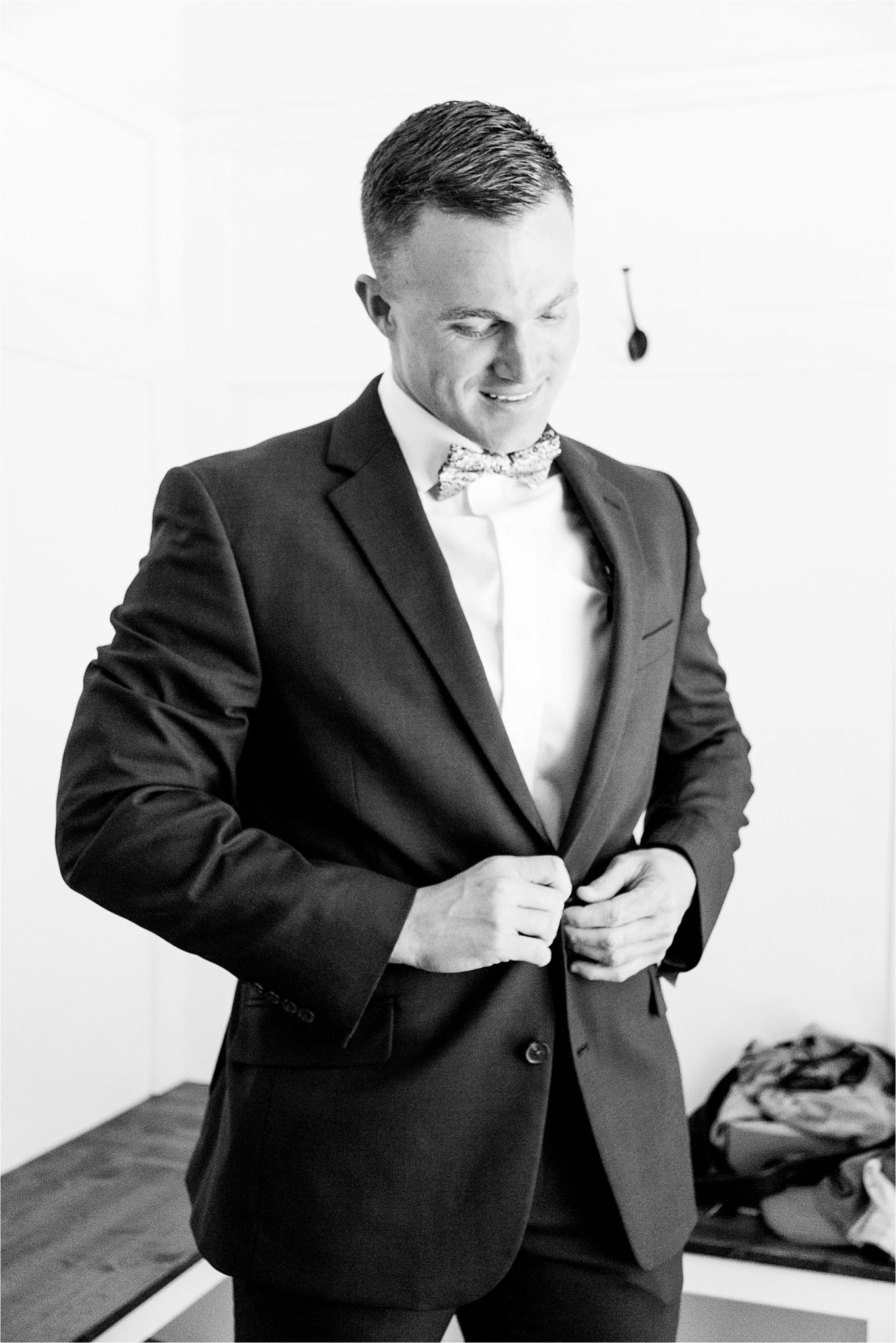 groom-getting-ready-fitted-suit-bow-tie-handsome